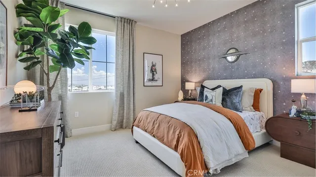 a bedroom with a bed and a potted plant