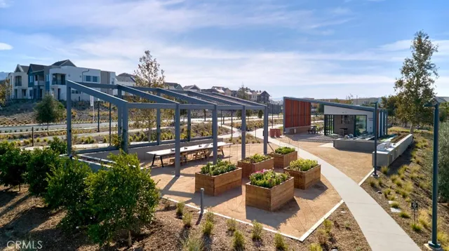 a view of a patio with couches chairs potted plants and water view
