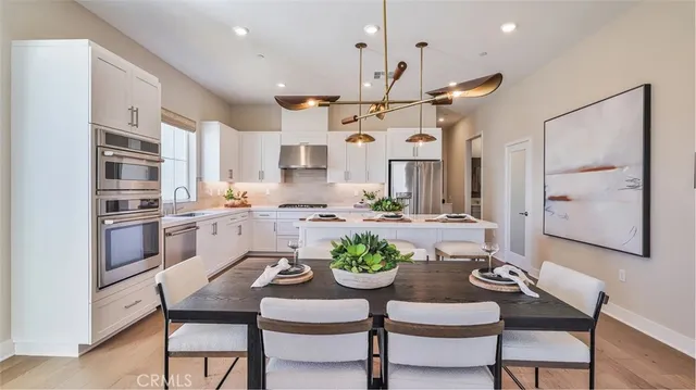 a view of kitchen with sink and refrigerator