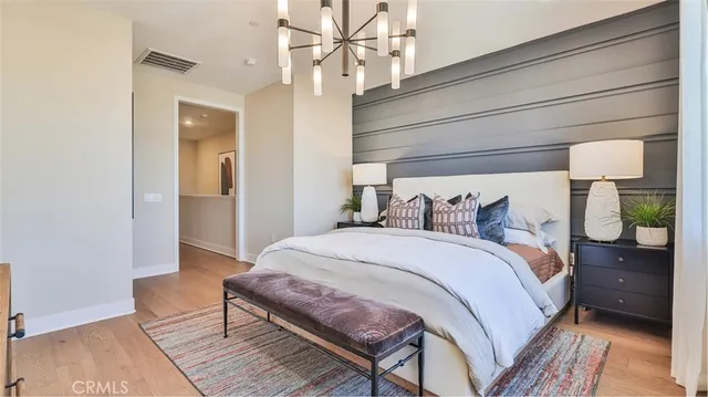 a bedroom with bed and wooden floor