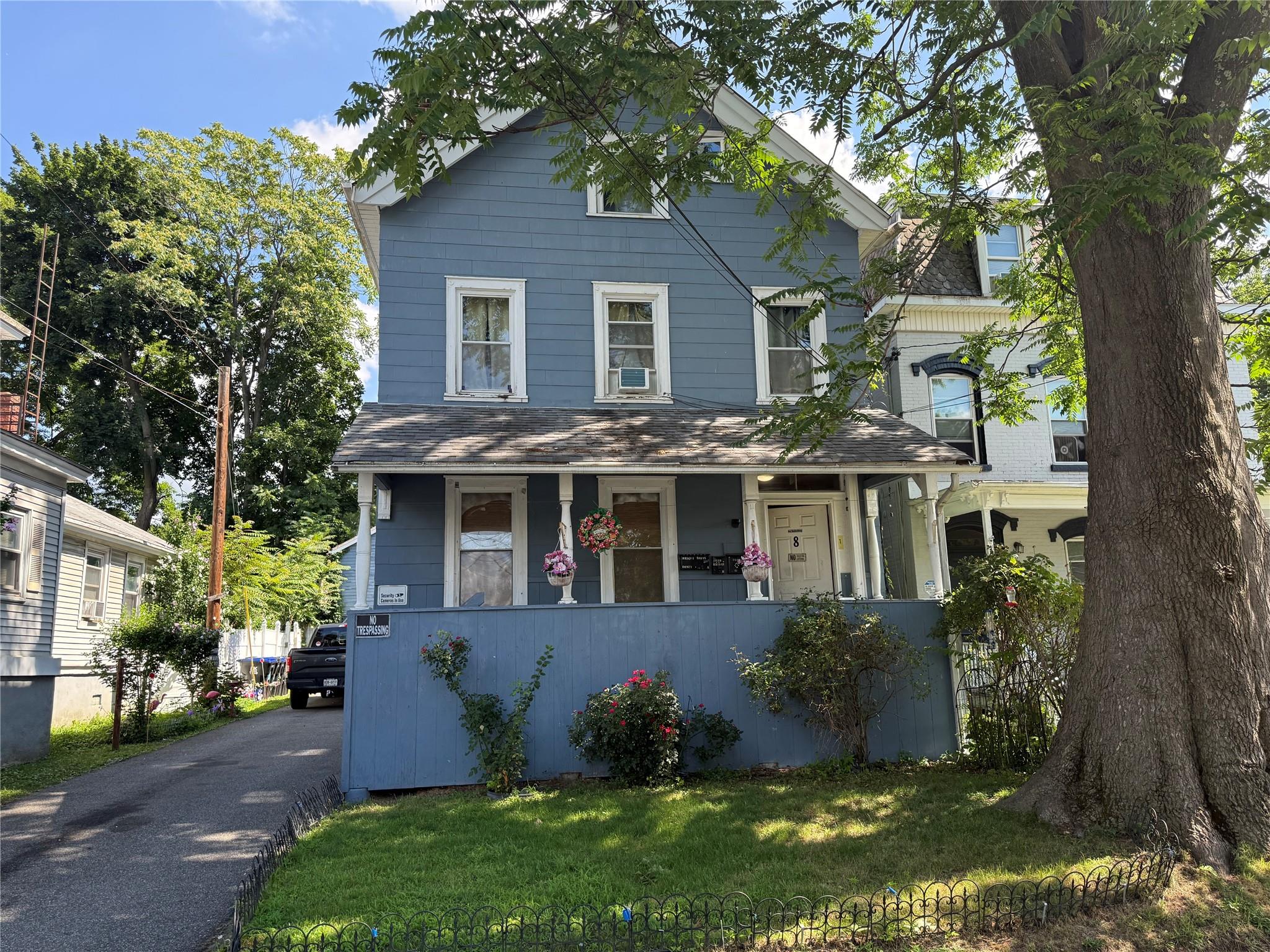 View of front of house with a porch and a front yard