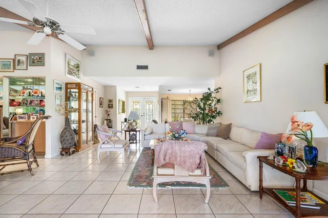 a living room with lots of furniture and a chandelier