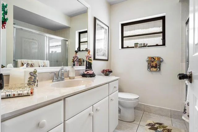 a bathroom with a toilet a sink and mirror