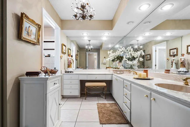 a large white kitchen with stainless steel appliances granite countertop a sink and dishwasher