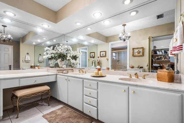 a kitchen with sink and white cabinets