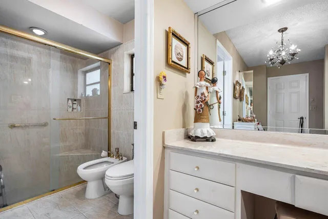 a bathroom with a granite countertop sink toilet and shower