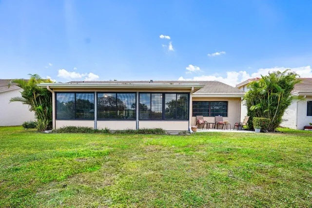 a view of a house with a yard and a porch