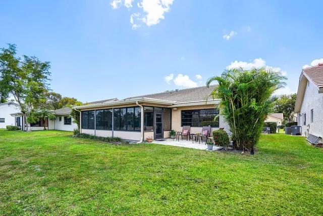 a view of a house with a yard porch and sitting area