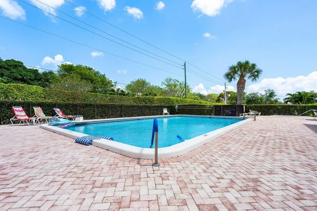 a view of a swimming pool and lounge chairs