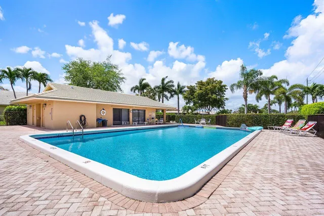 a view of a house with swimming pool and a yard