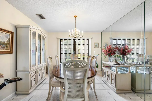 a view of a dining room with furniture and a chandelier