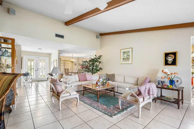 a living room with furniture and a painting on the wall