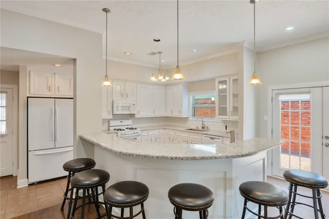 a kitchen with a table chairs stove and cabinets