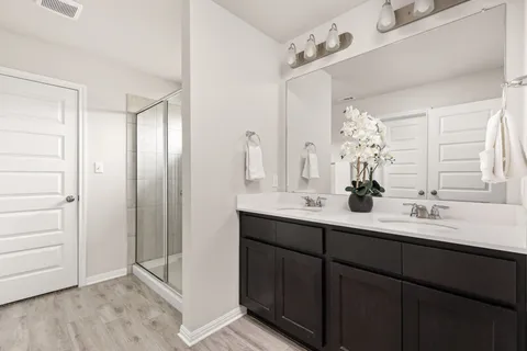 a bathroom with a double vanity sink and mirror