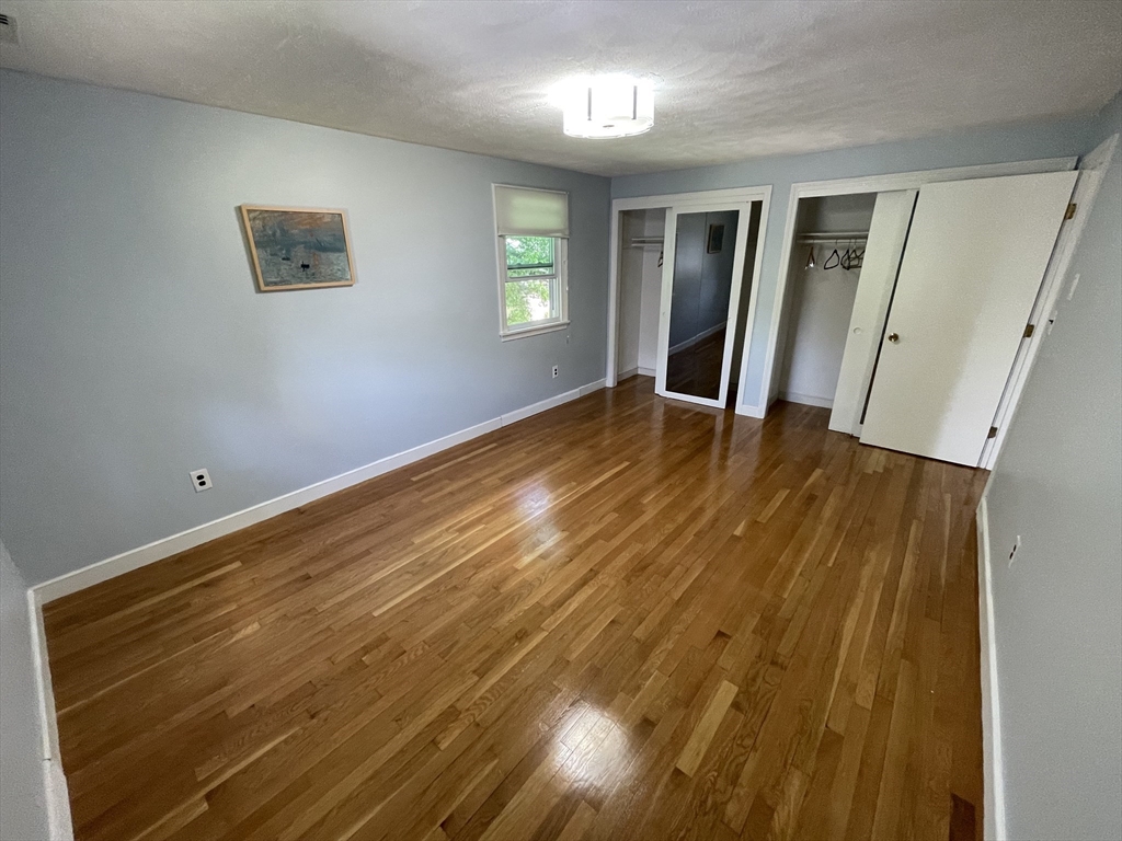 18 Charles Street Lexington, MA 02421 - Photo 17 of 30 a view of an empty room with wooden floor and a window