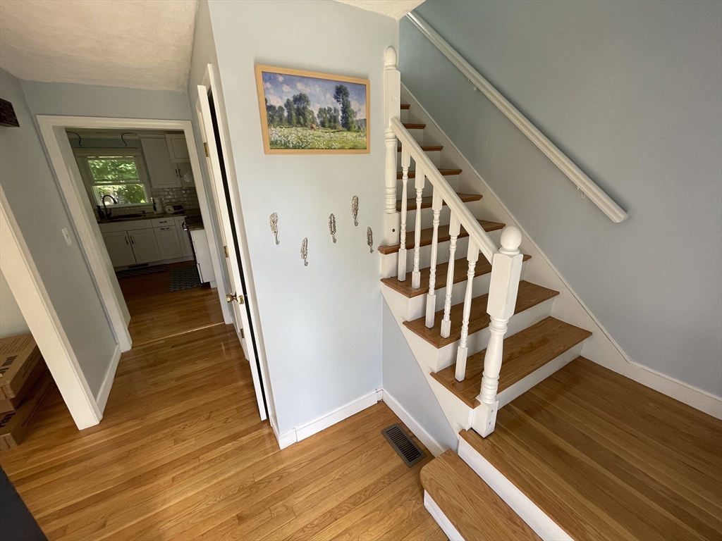 18 Charles Street Lexington, MA 02421 - Photo 21 of 30 a view of a livingroom with wooden floor and stairs