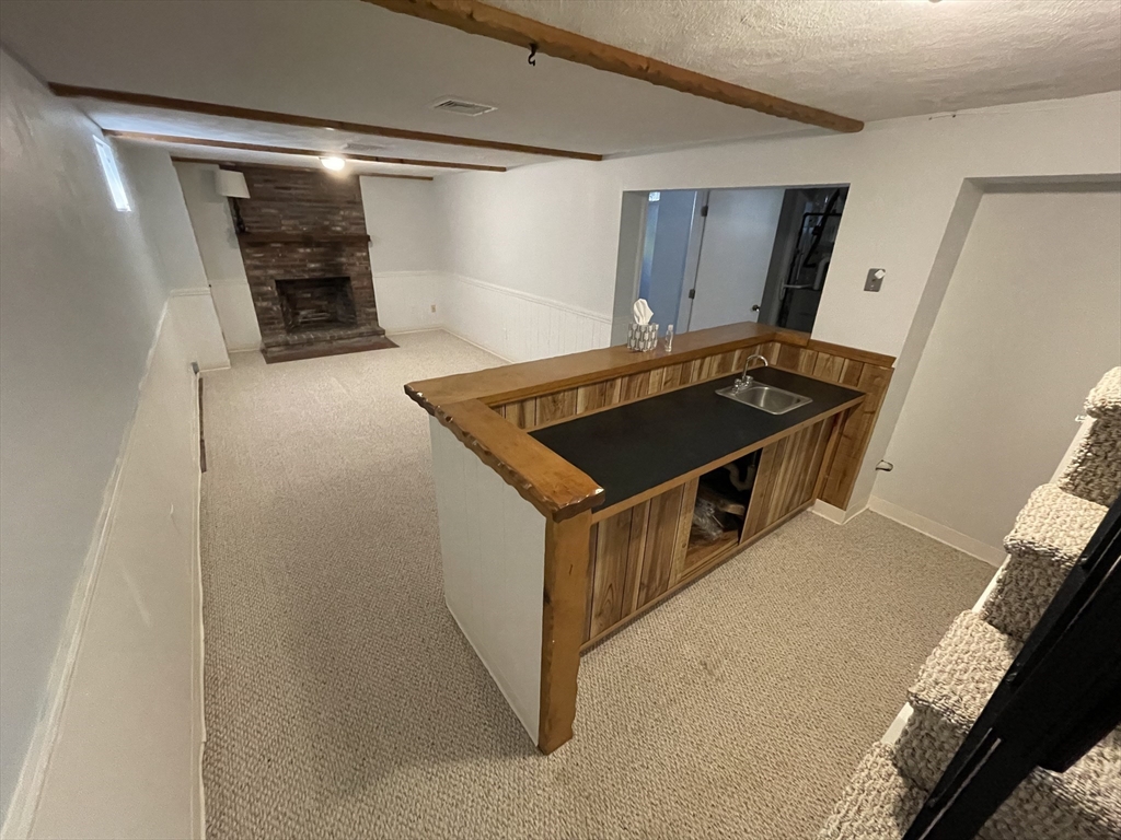 18 Charles Street Lexington, MA 02421 - Photo 23 of 30 a kitchen with stainless steel appliances granite countertop a stove and a refrigerator