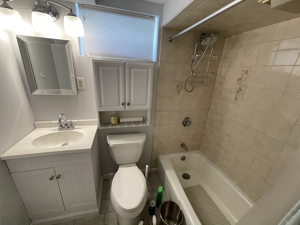 18 Charles Street Lexington, MA 02421 - Photo 27 of 30 a bathroom with a toilet sink shower and mirror