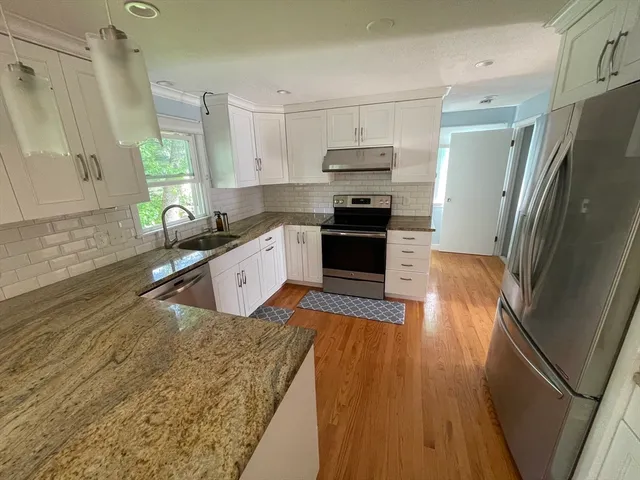 a kitchen with stainless steel appliances a refrigerator sink and stove