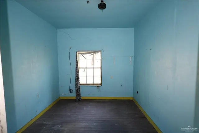 a bedroom with a rug and a window