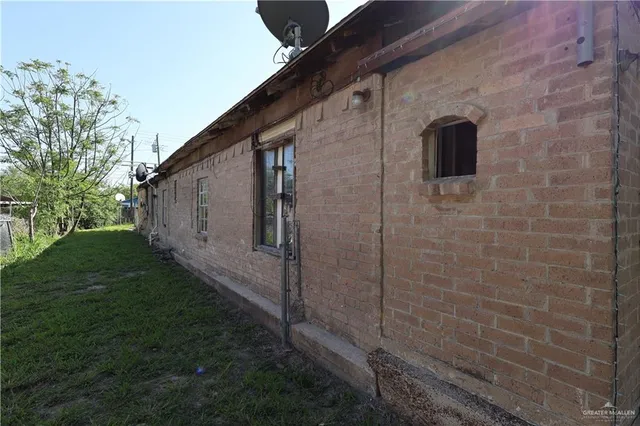 a backyard of a house with plants and trees