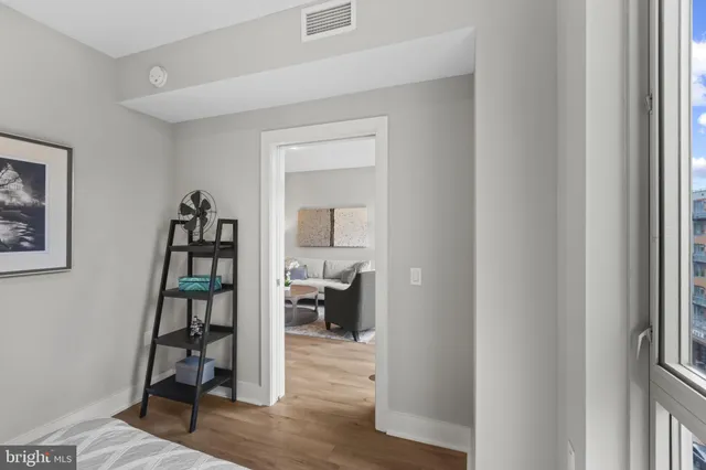 a view of a livingroom with wooden floor and furniture