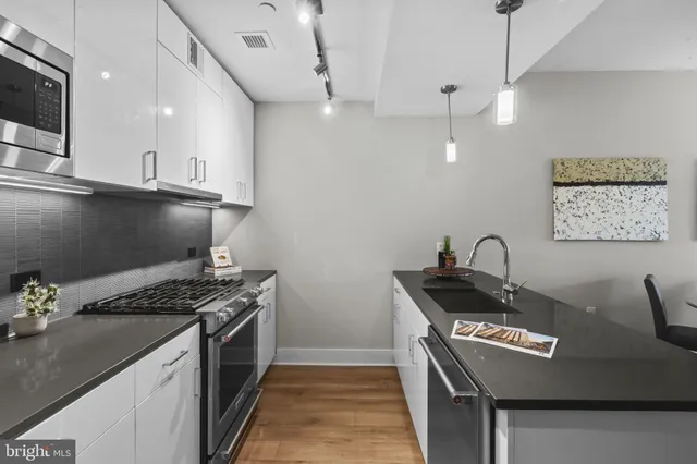 a kitchen with granite countertop a stove and a sink
