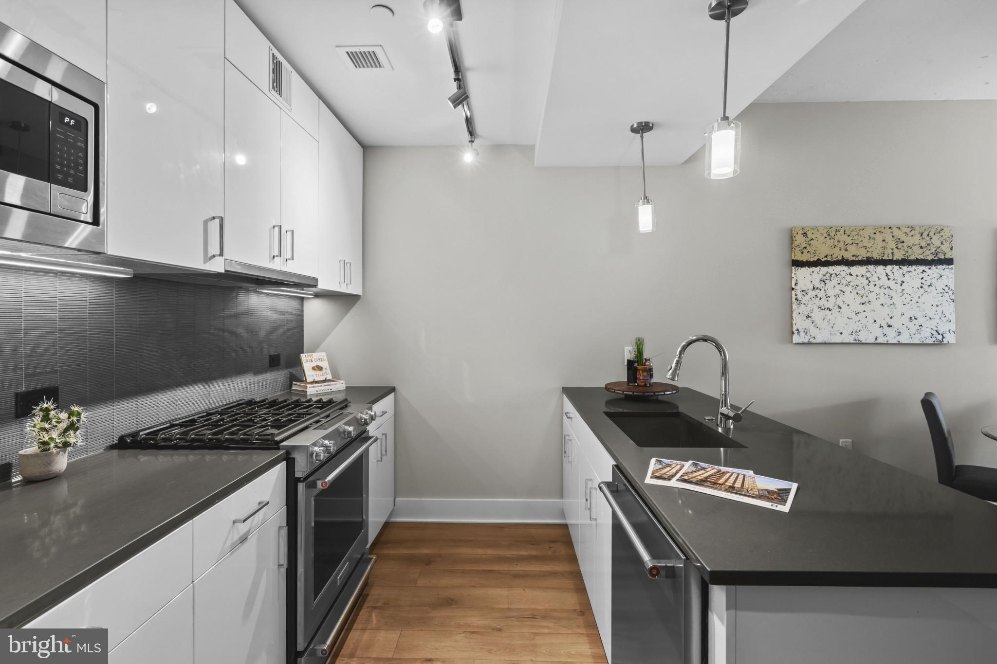 88 V Street Southwest, Unit 710 Washington, DC 20024 - Photo 7 of 31 a kitchen with granite countertop a stove and a sink