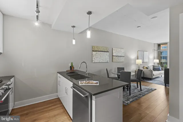 a kitchen with a stove and a wooden floor