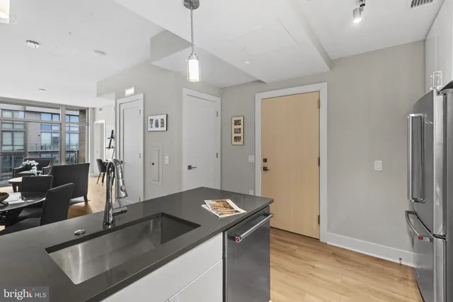 a kitchen with granite countertop a sink and a refrigerator