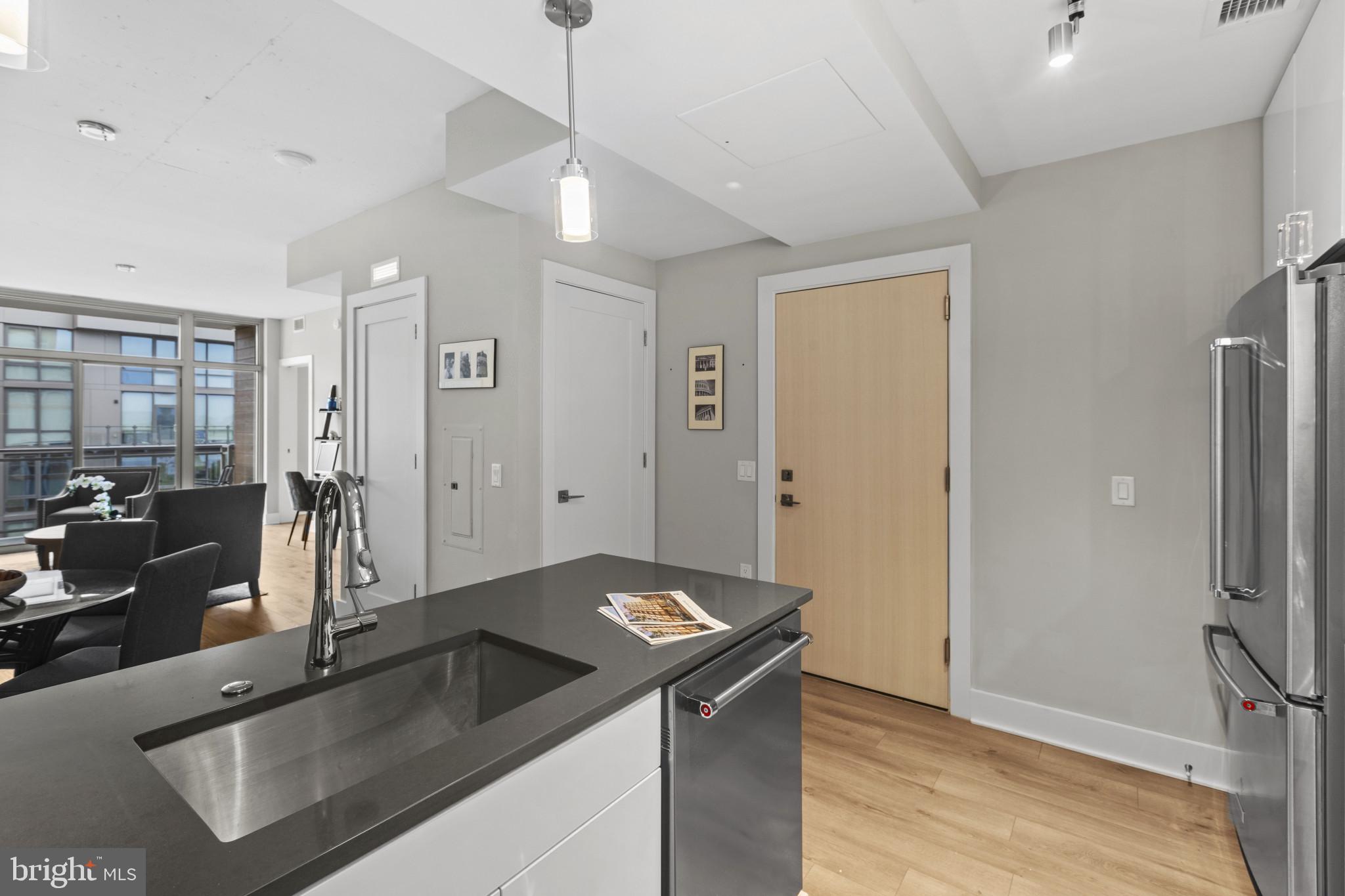 88 V Street Southwest, Unit 710 Washington, DC 20024 - Photo 9 of 31 a kitchen with granite countertop a sink and a refrigerator