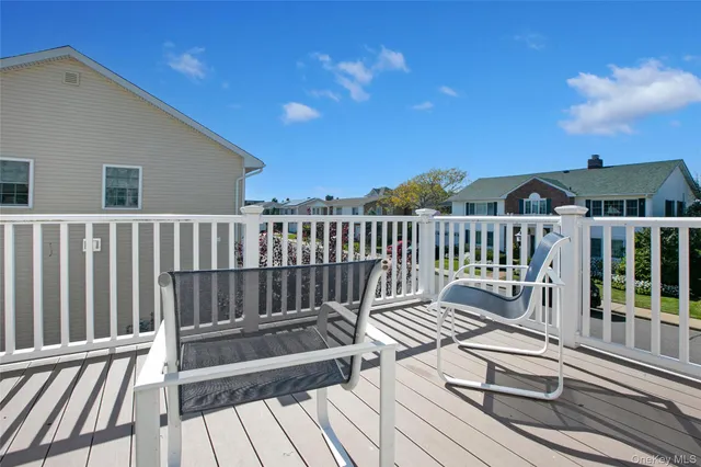 a view of balcony with wooden floor and fence