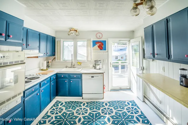 a kitchen with a sink stove and cabinets