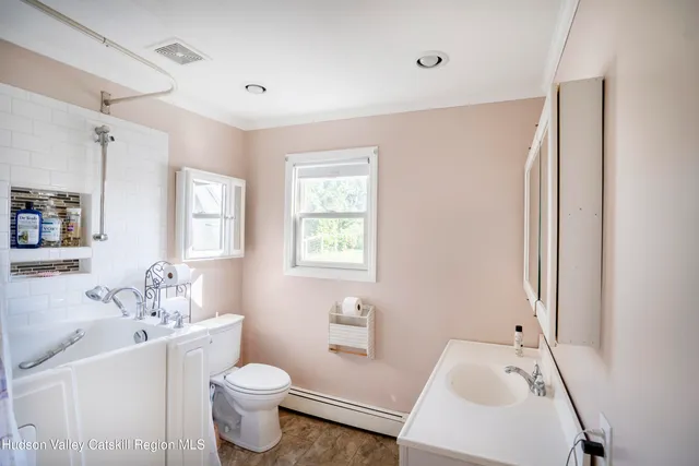 a bathroom with a sink toilet tub and shower