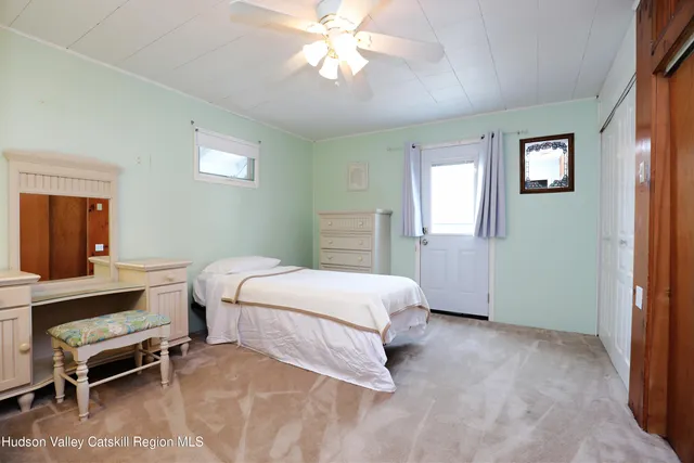 a spacious bedroom with a bed and a chandelier