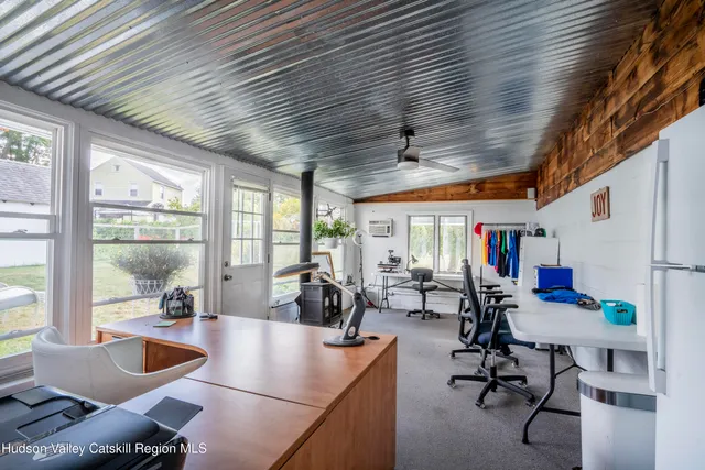 a view of a livingroom with furniture and a large window