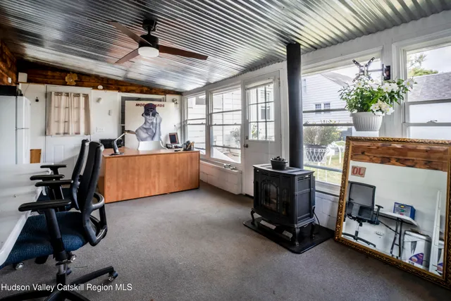 a living room with furniture gym equipment and a large window