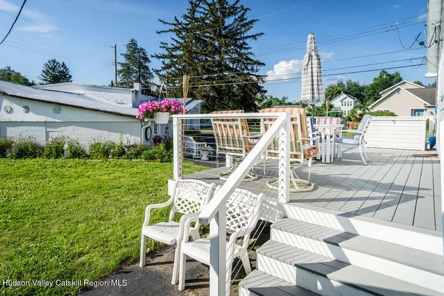 a view of a chair and tables in the patio with a fire pit