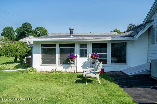 a chair and table in front of a house