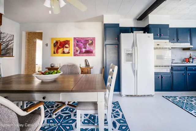a view of kitchen with stainless steel appliances granite countertop a refrigerator and a stove top oven