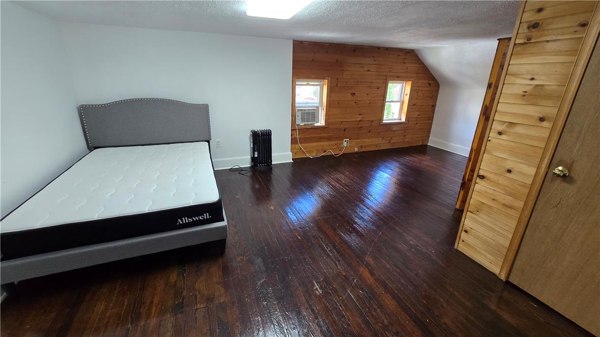 883 North Locust Street Hazleton, PA 18201 - Photo 68 of 83 Rich hardwood floors complement the natural wood paneling in this airy bedroom.