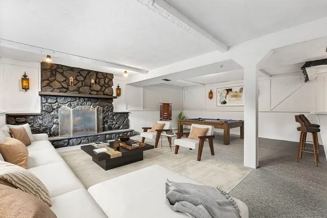 a living room with furniture a wall paintings and a couch