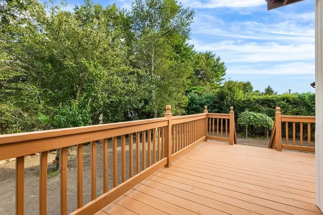 a balcony with wooden floor and fence