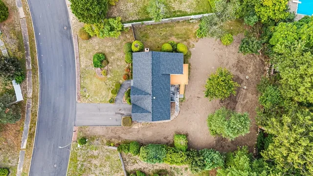 an aerial view of a house with a yard