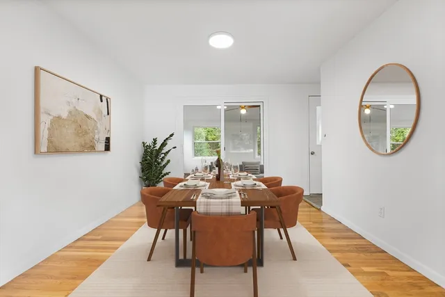 a dining room with furniture and a mirror