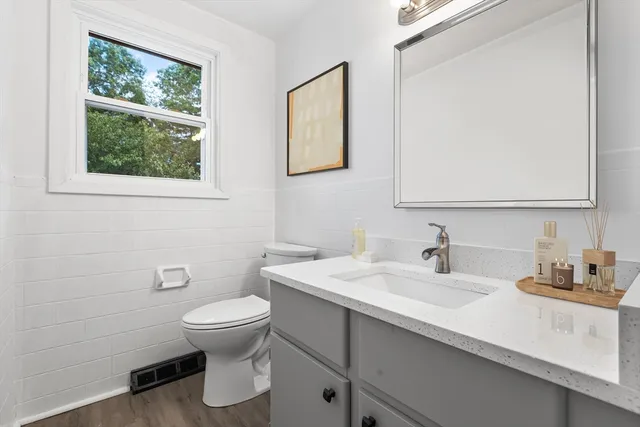 a bathroom with a sink a toilet and mirror