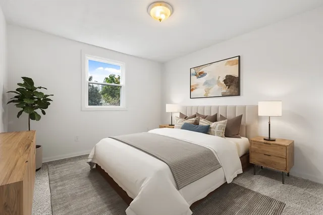 a bedroom with bed and a window