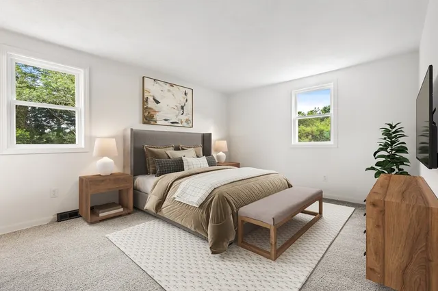 a bedroom with a bed and a painting on the wall