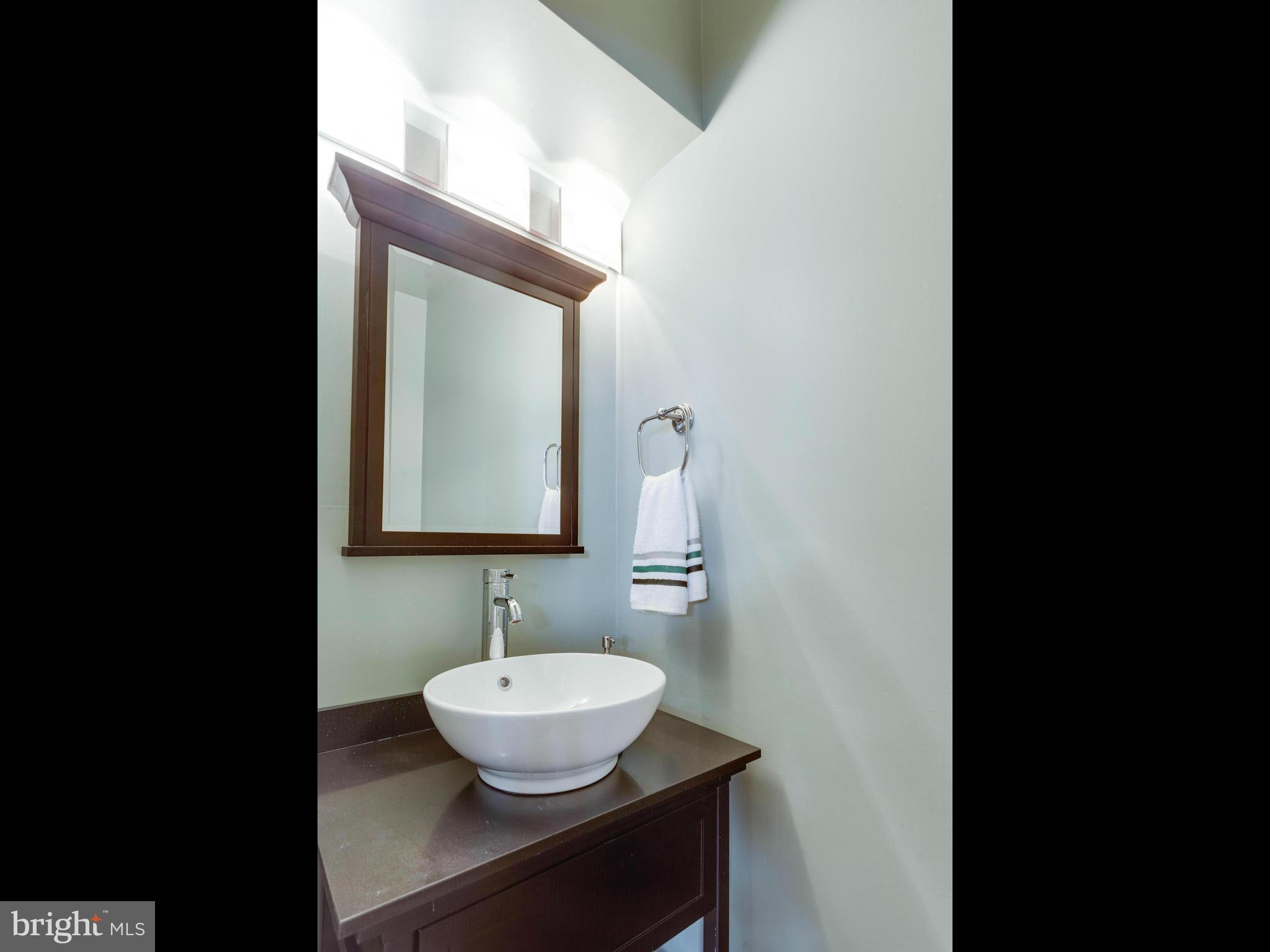 2357 Glade Bank Way Reston, VA 20191 - Photo 18 of 30 a view of a bathroom with a sink and mirror