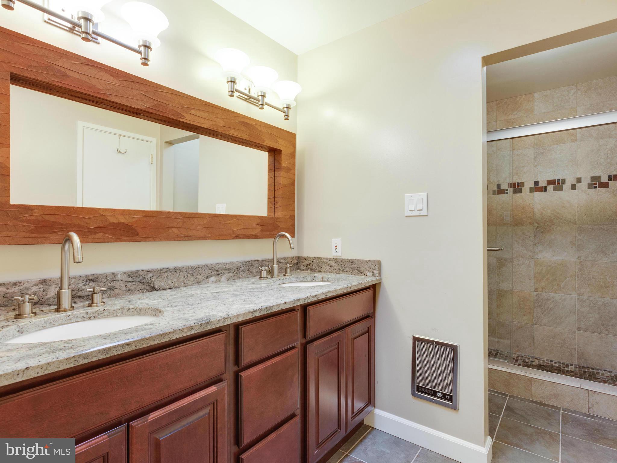 2357 Glade Bank Way Reston, VA 20191 - Photo 19 of 30 a bathroom with a granite countertop sink and a mirror